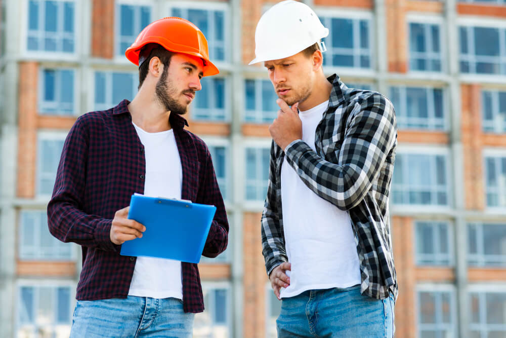 Homeowner discussing roof inspection questions with a roofing professional